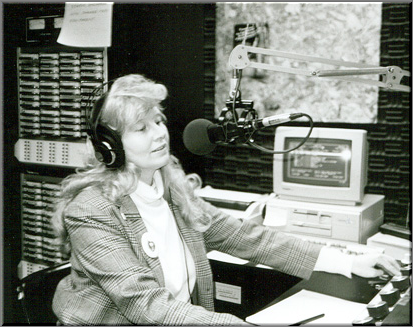 Archival photograph of Penny Hamilton at a radio microphone